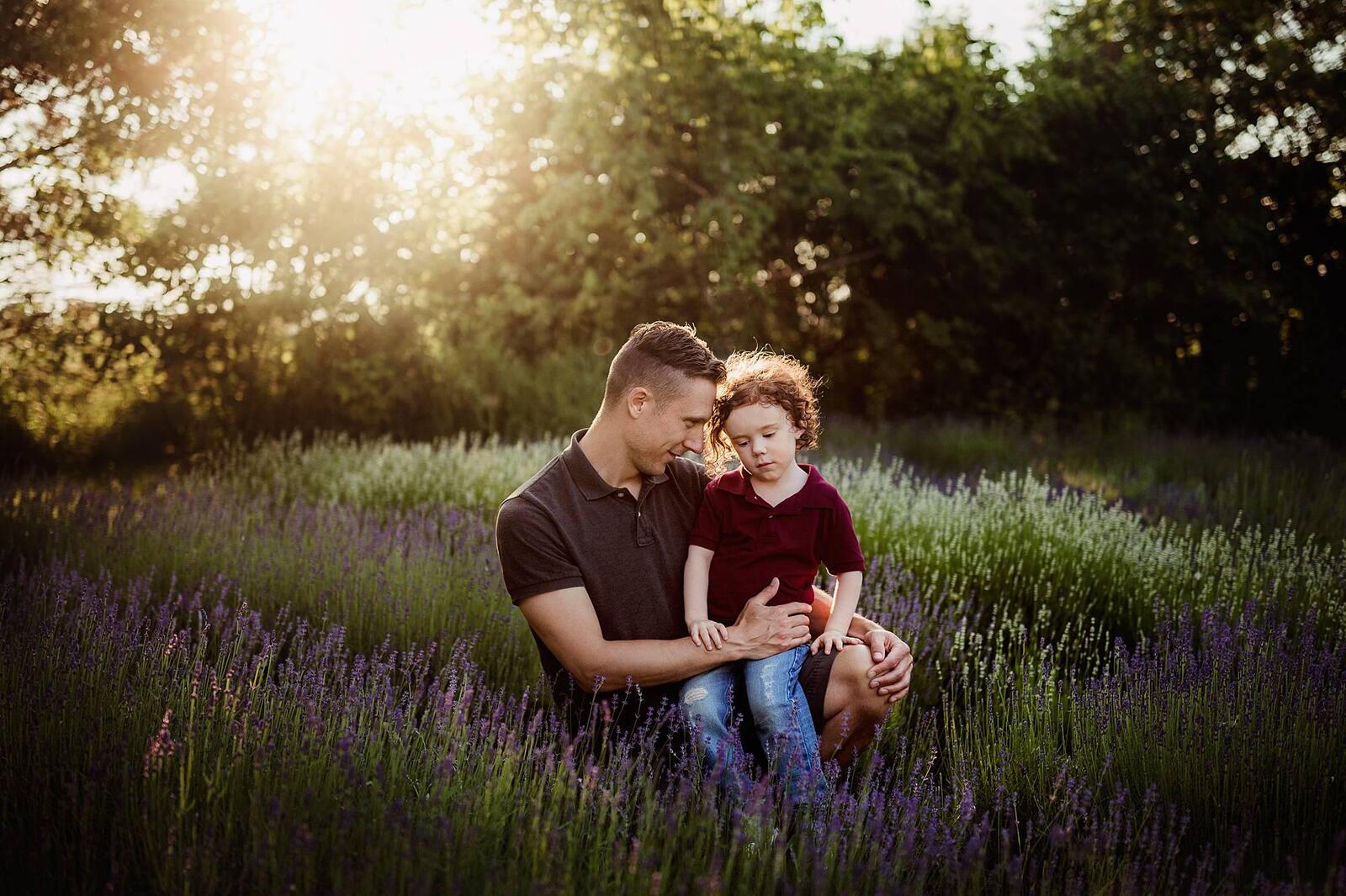 Dad and son having a quiet moment in sun-soaked lavender field