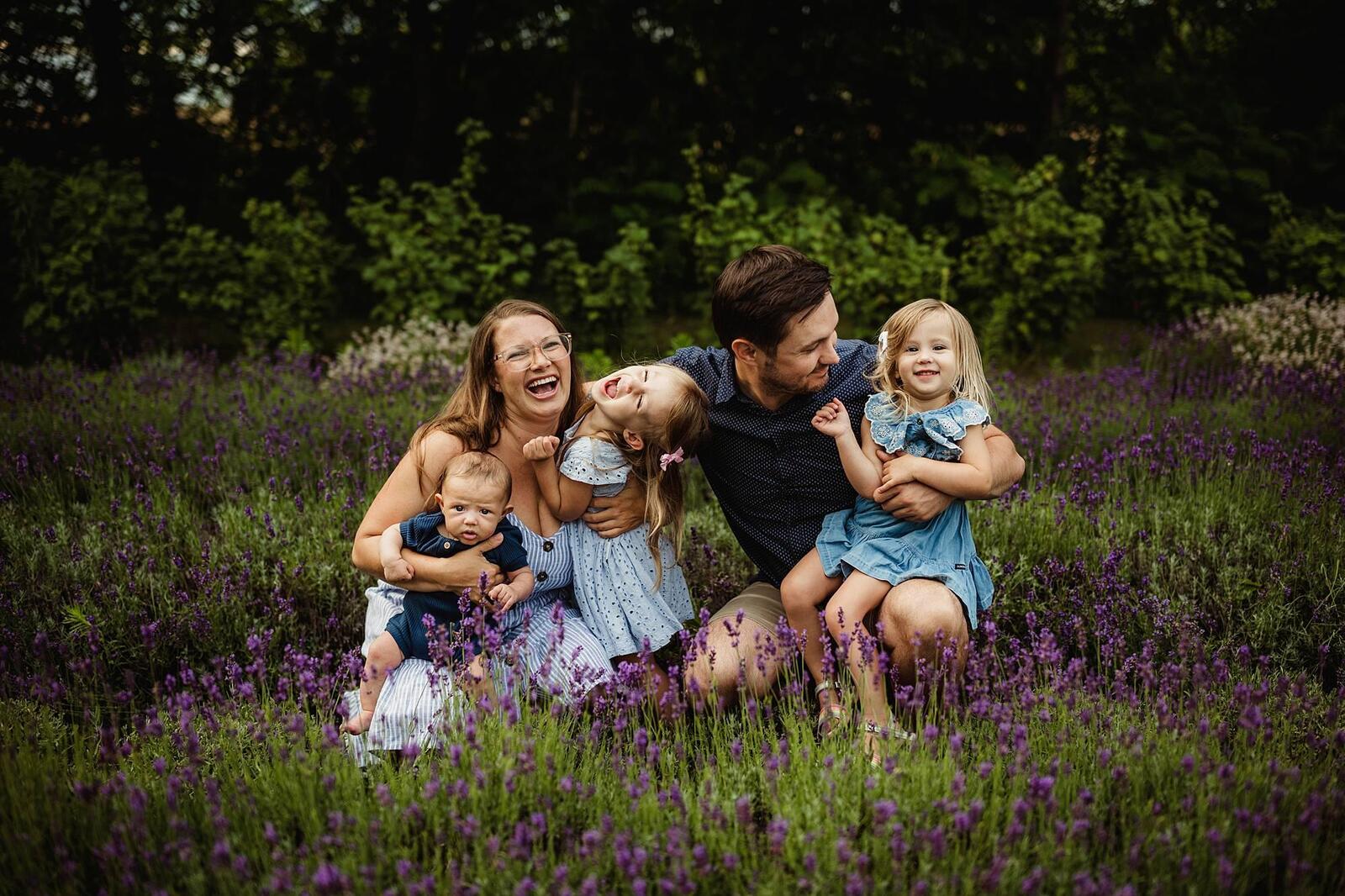 family laughing in lavender field