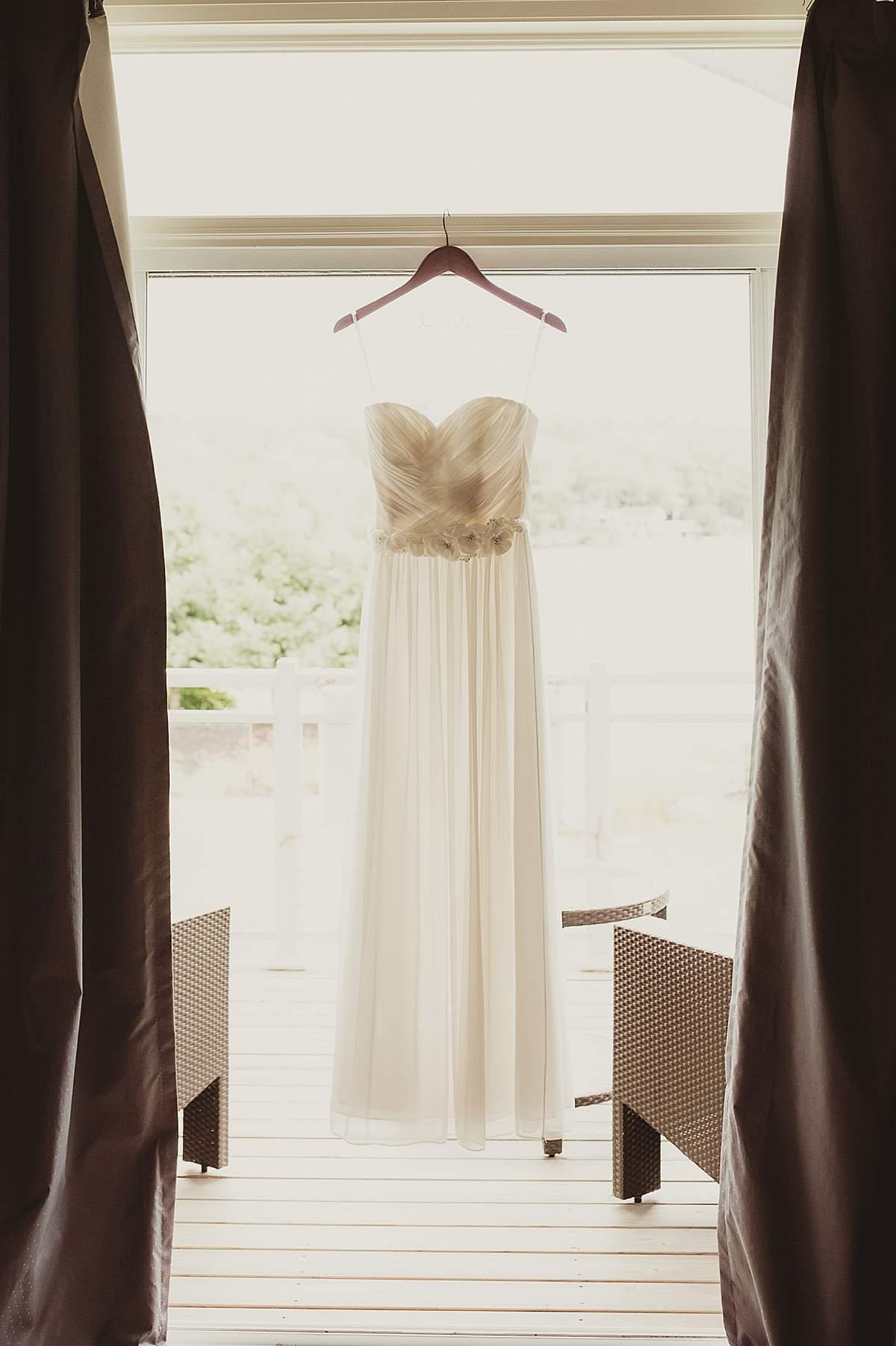 bridal dress hanging from open doorway