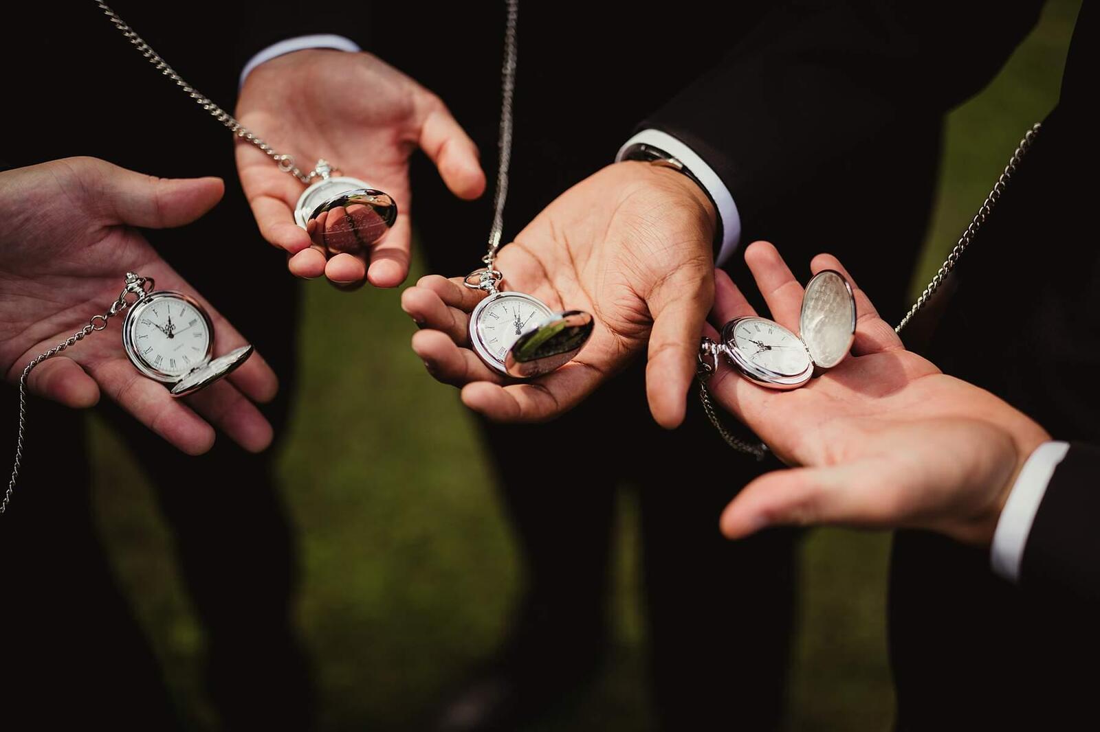 groomsmen showing off their pocket watches